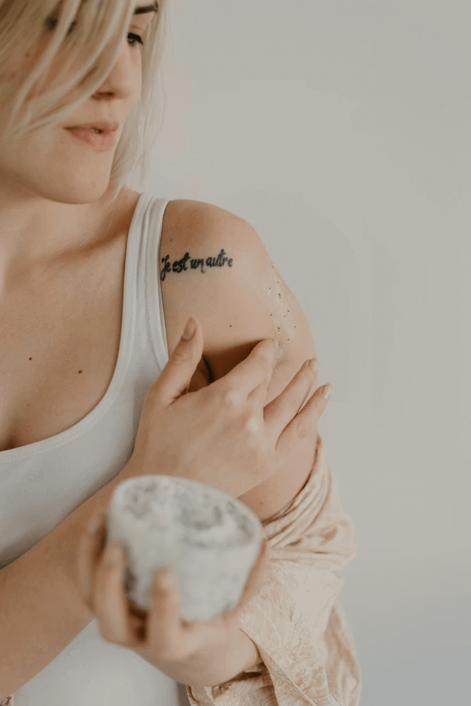 A woman displaying a tattoo on her arm