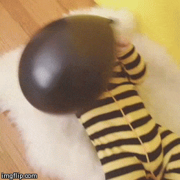 baby playing with balloon