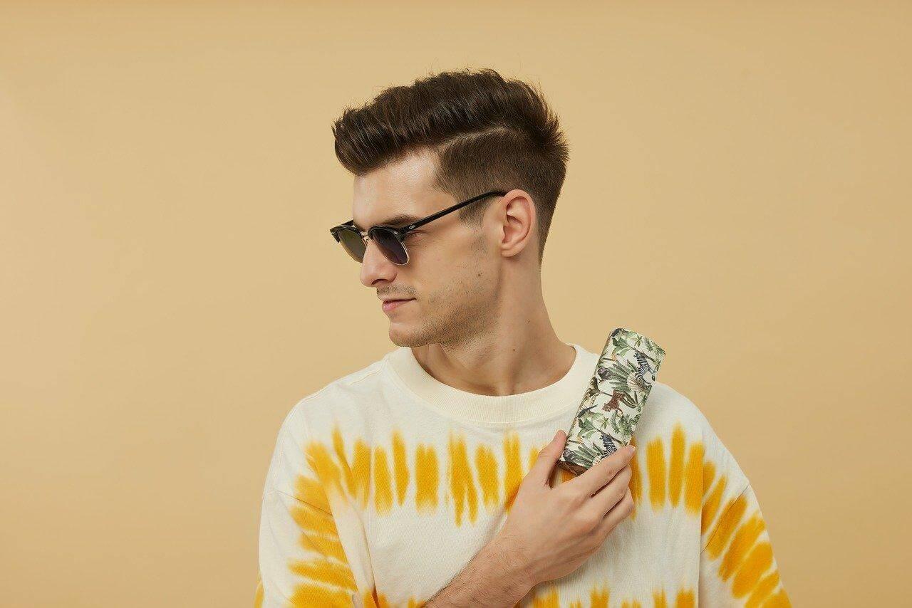 Man in tie dye shirt using cell phone