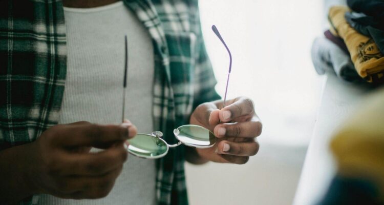 Person holding glasses for photography tips