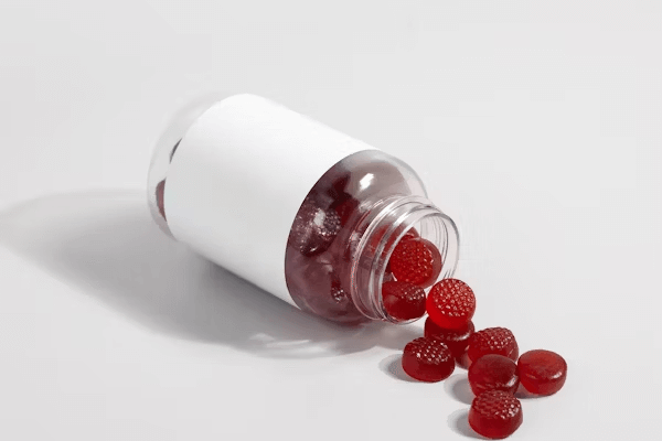 Raspberries spilling from a bottle