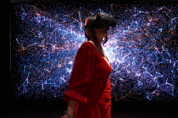 Woman in front of starry display at virtual fashion event