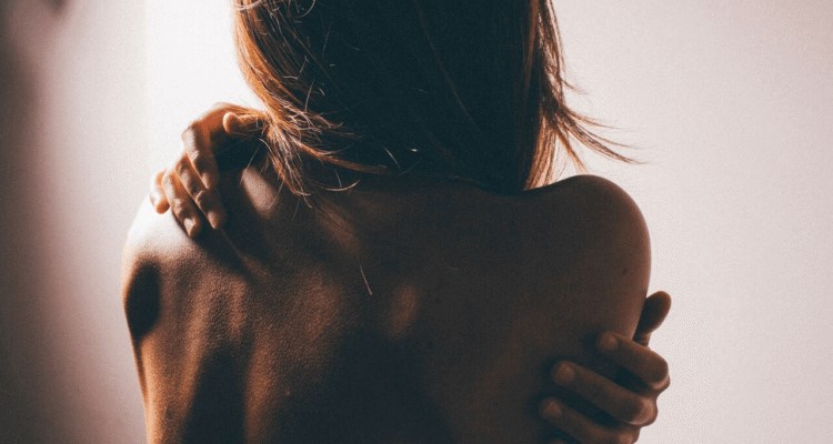 Woman practicing self-care by the window