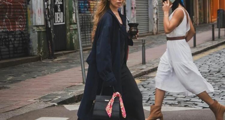 Woman walking across street talking on cellphone