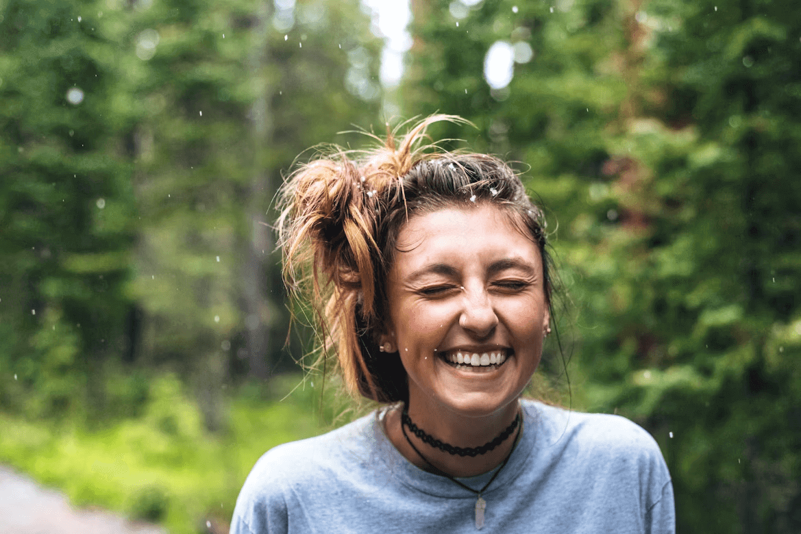 Woman with a bun smiling confidently